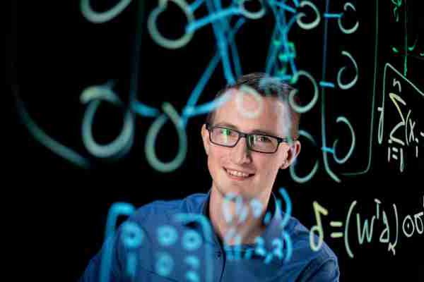 A college professor is seen through lightboard drawings. 